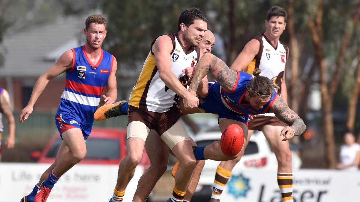 HOT CONTEST: Huntly's Chris Gleeson and North Bendigo's Jeremy Mills battle for possession on Saturday. Picture: GLENN DANIELS