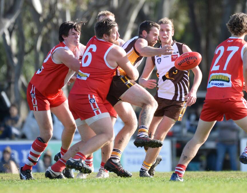 GOTCHA: Elmore coach Danny Brewster lays a tackle on Huntly's Jack Daley on Saturday. The Hawks returned to the winner's list with a 92-point victory, while the Bloods remain winless. Pictures: GLENN DANIELS