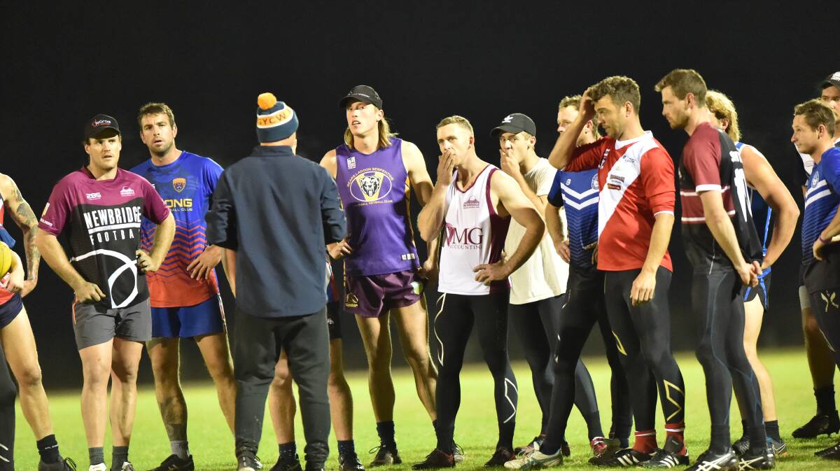 ALL EARS: Loddon Valley players listen to coach Wayne Mitrovic at Thursday night's training session.