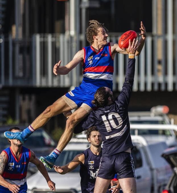 BULLDOG SOARS: North Bendigo forward Dylan Klemm, who kicked four goals, gets airborne against Mount Pleasant's Chris Down on Saturday. Picture: STEVE WOMERSLEY