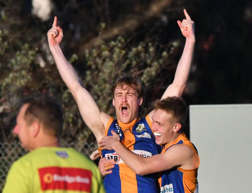 BULLDOGS ON A ROLL: Golden Square's Jayden Burke celebrates one of his five goals with team-mate Will Thrum during Saturday's win over Sandhurst at Wade Street. Square has now won seven in a row. Picture: NONI HYETT