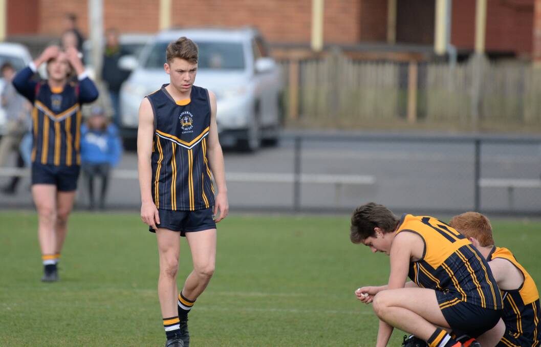 DISAPPOINTMENT: Catherine McAuley College players lament a three-point defeat at the final siren.