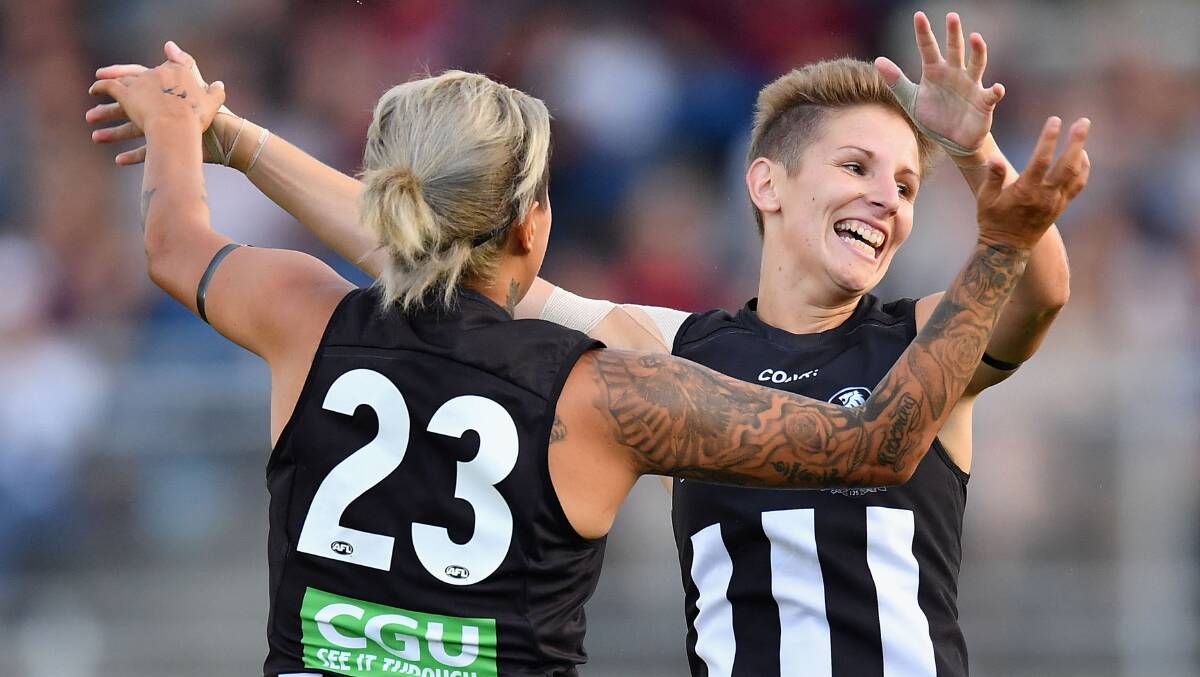 THROUGH THE BIG STICKS: Emma Grant celebrates with team-mate Moana Hope after kicking a goal on Saturday. Picture: GETTY IMAGES