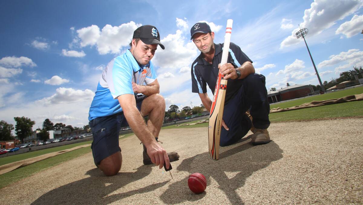 Strathdale-Maristians captain Linton Jacobs and Eaglehawk skipper Jason Abbott inspect the QEO wicket on Thursday. Picture: GLENN DANIELS