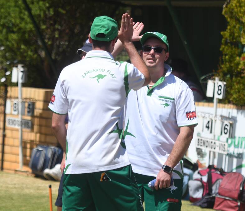 UP AND ABOUT: Kangaroo Flat skipper Tom Russell high fives team-mate Mitch Hocking on Saturday. Russell's rink had a 28-18 win over Geoff Briggs. Picture: LUKE WEST