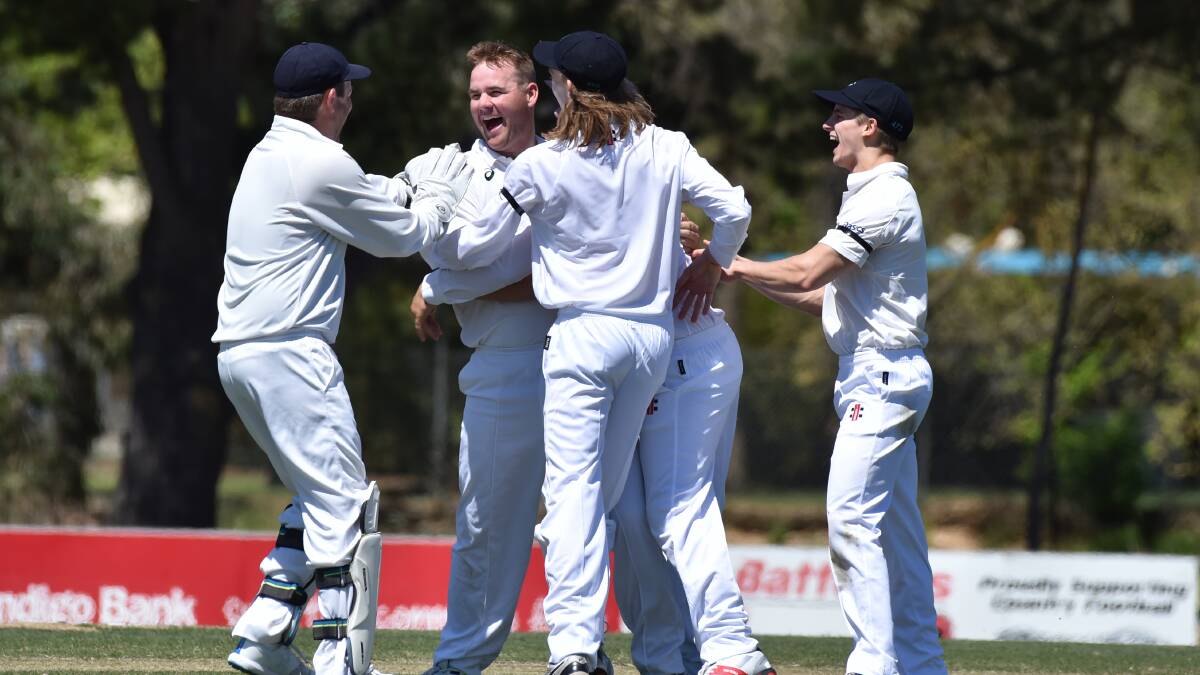 GET AROUND HIM: Eaglehawk players celebrate one of Nick Farley's four wickets against White Hills at Scott Street. Picture: GLENN DANIELS