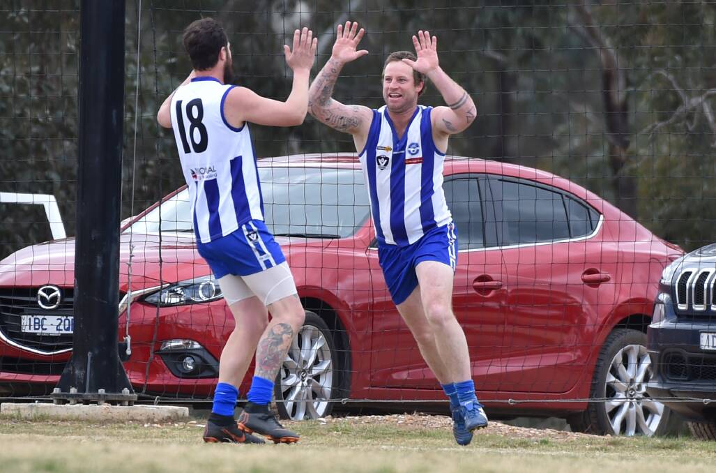HIGH FIVES: Mitiamo's Ryan Wellington (No.18) and Tom Grant celebrate a goal on Sunday during the Superoos' one-point first semi-final win over Pyramid Hill. The win keeps the Superoos' hopes of winning their first flag since 2009 alive. Pictures: DARREN HOWE