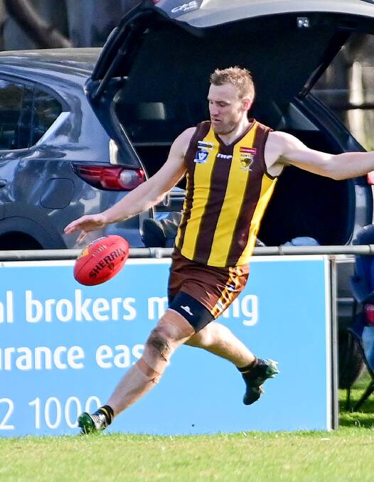 LEADER: Huntly coach Stacy Fiske kicks against Elmore on Saturday. The Hawks prevailed at home by 27 points. Picture: BRENDAN McCARTHY