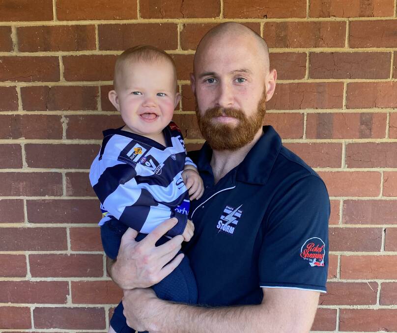 WAIT ALMOST OVER: Strathfieldsaye captain Lachlan Sharp with 13-month-old son Tige, who will watch his first Storm game on Friday at Tannery Lane against Sandhurst. It will be the first BFNL match played for 559 days.