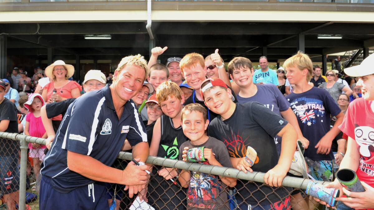 ALL SMILES: Shane Warne with fans at the John Forbes Tribute Match at Kangaroo Flat's Dower Park in February, 2011.