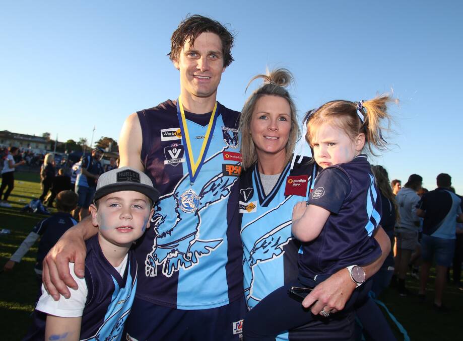 SPECIAL DAY: Tim Hill with wife Jo and children Dusty and Molly after the Hawks' 2018 grand final win against Strathfieldsaye. Hill played in flags with the Hawks in 2018, which he captained, and 2008. Picture: GLENN DANIELS