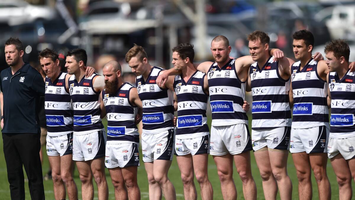 CALM BEFORE THE STORM: Strathfieldsaye lines up for the national anthem prior to the start of Saturday's BFNL grand final against Eaglehawk at the QEO. In what was the Storm's fifth grand final in six years, they were beaten by 49 points. Picture: GLENN DANIELS