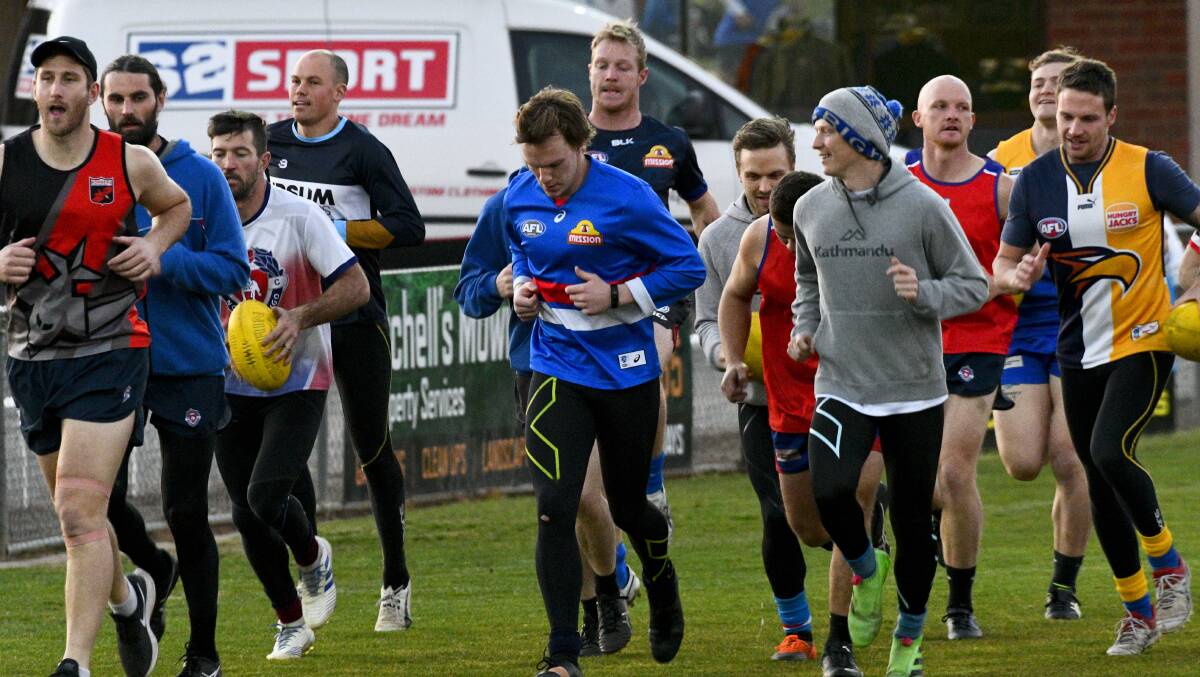 GEARING UP: North Bendigo players go through their paces at training on Thursday night. The Bulldogs are playing in their sixth grand final in a row. Picture: NONI HYETT