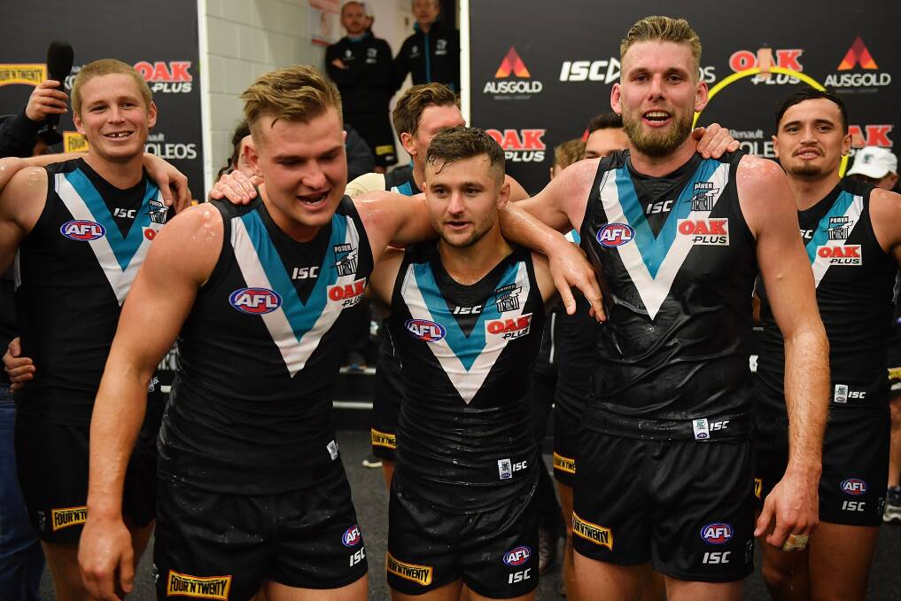 Ollie Wines (left) with team-mates Sam Gray and Jackson Trengove after Saturday's win over North Melbourne. Picture: GETTY IMAGES