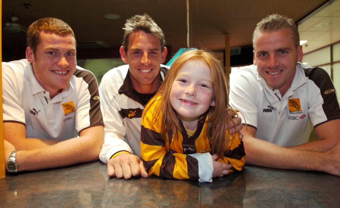 Jarryd Roughead, Danny Jacobs and Rick Ladson with Hawthorn fan Alisha Lakey at the Limerick Hotel in Bendigo in 2006.