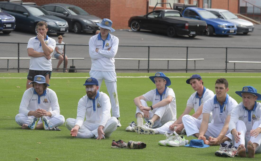 Disappointed Golden Square players during the post-match presentation.