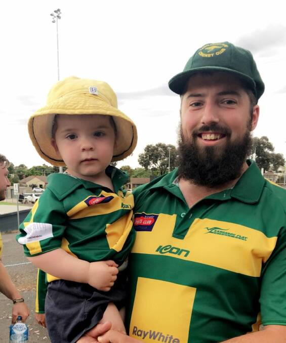 SMILING ASSASSIN: Kangaroo Flat's Brent Hamblin with son Karter after his 11-wicket haul over the weekend in the BDCA.