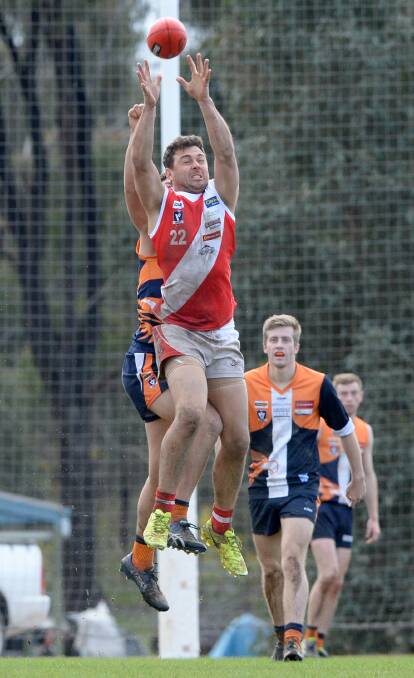 CONTEST: Bridgewater's Darren Clutton flies for a mark during the Mean Machine's 60-point win over Maiden Gully YCW on Saturday. Picture: DARREN HOWE
