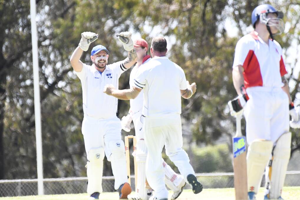 LONG-AWAITED WIN: California Gully wicket-keeper Mick Galvin and Brad Webster (back turned) celebrate a wicket against Mandurang on Saturday. The Cobras won by 82 runs in their first victory since round one. Picture: NONI HYETT