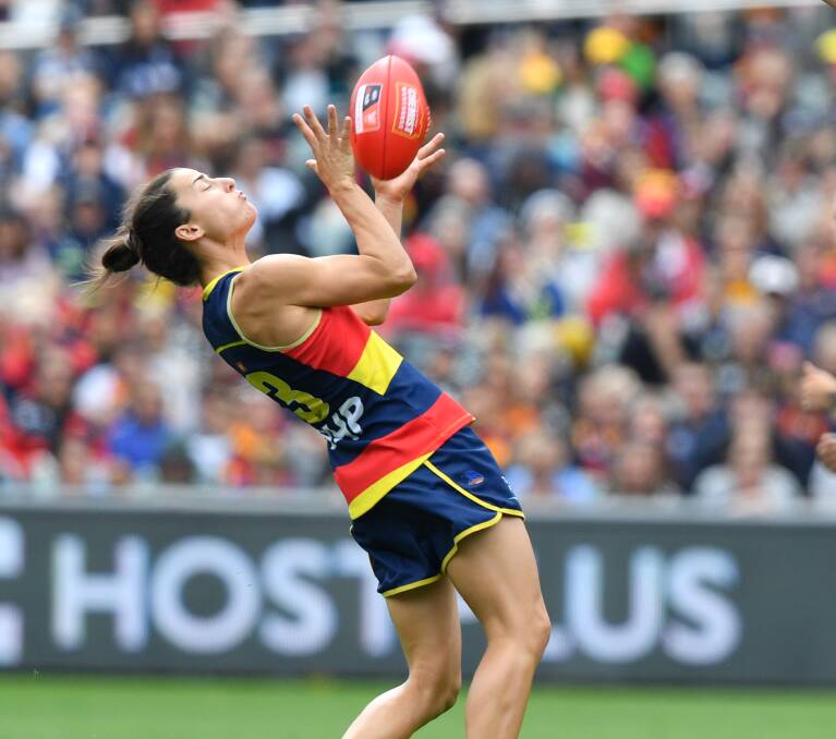 CROWS SOAR: Adelaide's Angela Foley takes a mark during Sunday's AFLW grand final win over Carlton. The Crows won by 45 points in front of a record crowd of 53,034 at the Adelaide Oval. Picture: AAP IMAGE