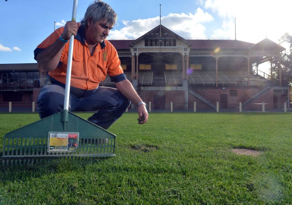 Council worker Andrew Roberts repairing some of the 80 holes at Princes Park back in April of 2013.