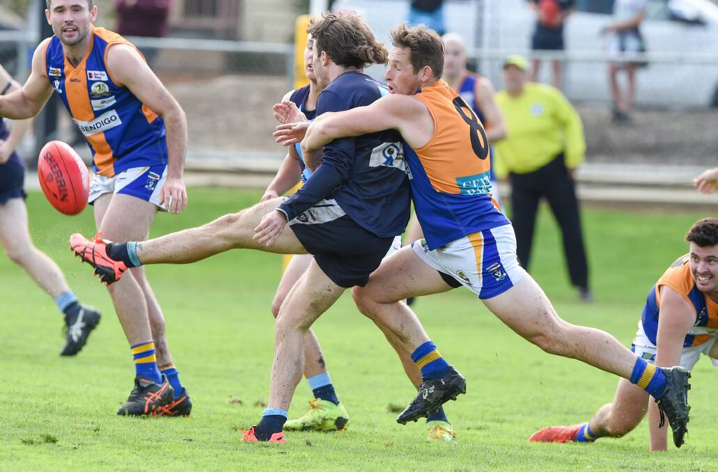 GOT HIM: Golden Square midfielder Terry Reeves lays a tackle against Eaglehawk earlier this season. Picture: DARREN HOWE