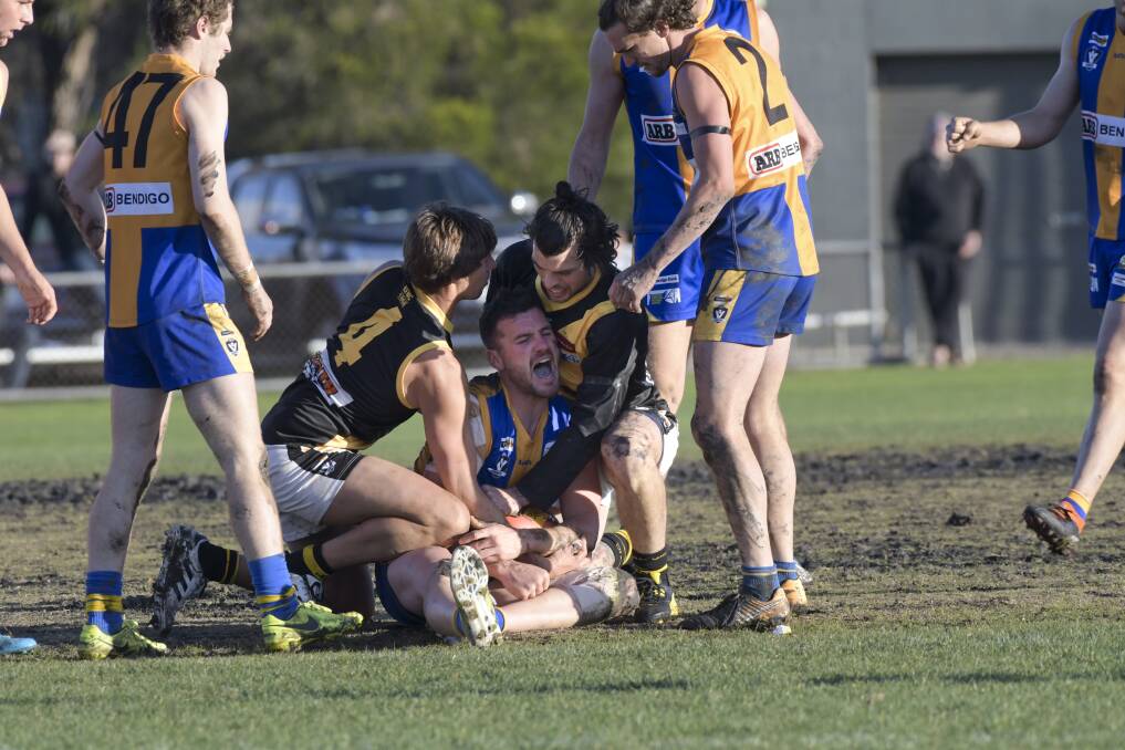 OUCH: Golden Square's Travis Baird, who is caught between Rhys Magin and Hamish Govan, suffers a dislocated shoulder recurrence during the third quarter of Saturday's 34-point win over Kyneton. Picture: NONI HYETT