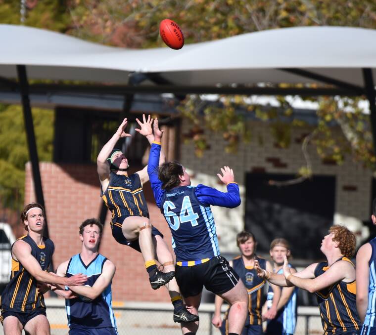 LEAP: Catherine McAuley College's Isaac Carracher flies for a mark during Wednesday's game against Mornington Secondary College. CMC won the semi-final in a canter by 133 points at the QEO. Picture: GLENN DANIELS