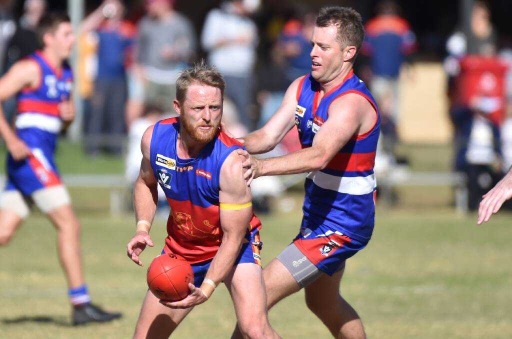 HARD-FOUGHT: Pyramid Hill's Gavin James puts the pressure on Marong's Ben Gregg during Saturday's contest won by the Bulldogs by 23 points. Picture: GLENN DANIELS