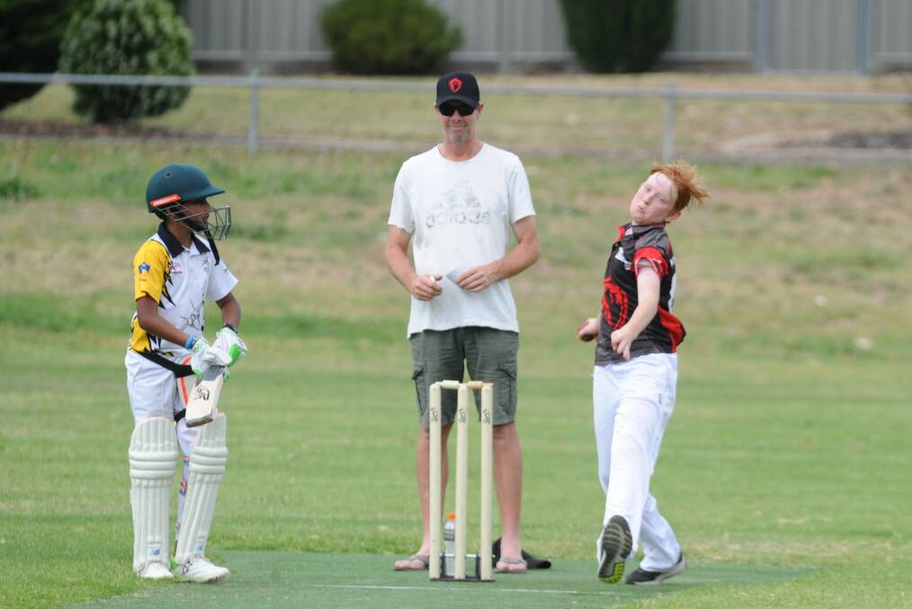 DETERMINED: White Hills' Jack McMurray bowls in the Demons' under-14B game against Strathfieldsaye Yellow at Finn Street. The Demons won by 35 runs after answering the Jets' 7-102 with 7-137. Pictures: ADAM BOURKE