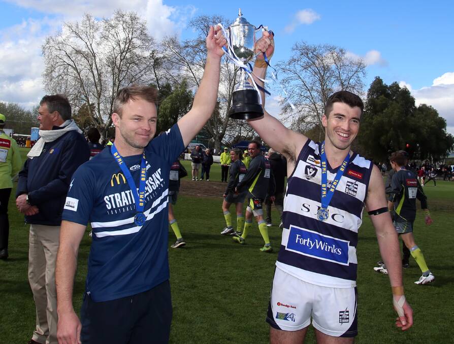 SILVERWARE: Strathfieldsaye coach Shannon Geary and captain James Blood with the reserves premiership cup.