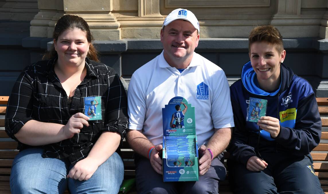 PINS FOR A CAUSE: Michelle Marschall, Denis Grinton and Emma Grant with the Ladder premiership cup pins. Picture: LUKE WEST