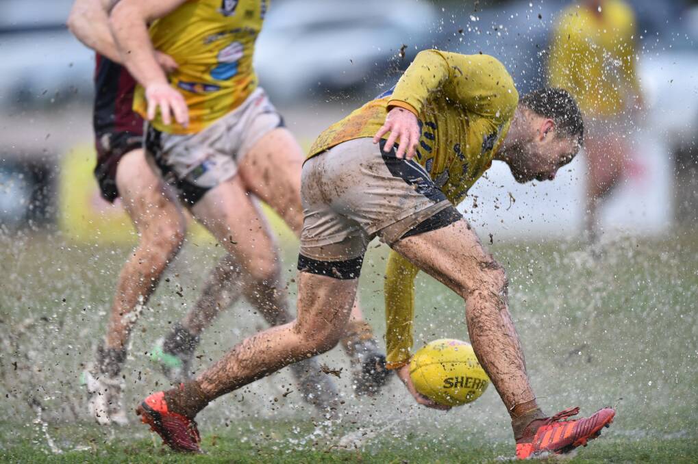 SKILFUL: Strathfieldsaye veteran Shannon Geary with a one-handed pick-up in the wet on Saturday.