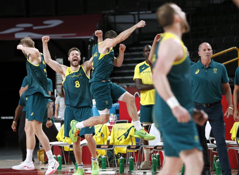 ELATION: Matthew Dellavedova (No.8) celebrates Australia's bronze medal triumph over Slovenia on Saturday night. Picture: EPA, KIYOSHI OTA
