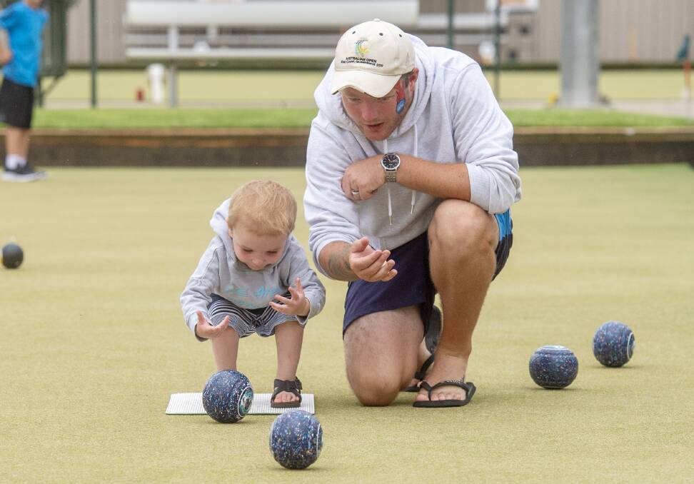 HOME STRETCH: Brad Marron and son Oliver in the last hour of his bowl-a-thon at Bendigo East on Wednesday. Picture: DARREN HOWE