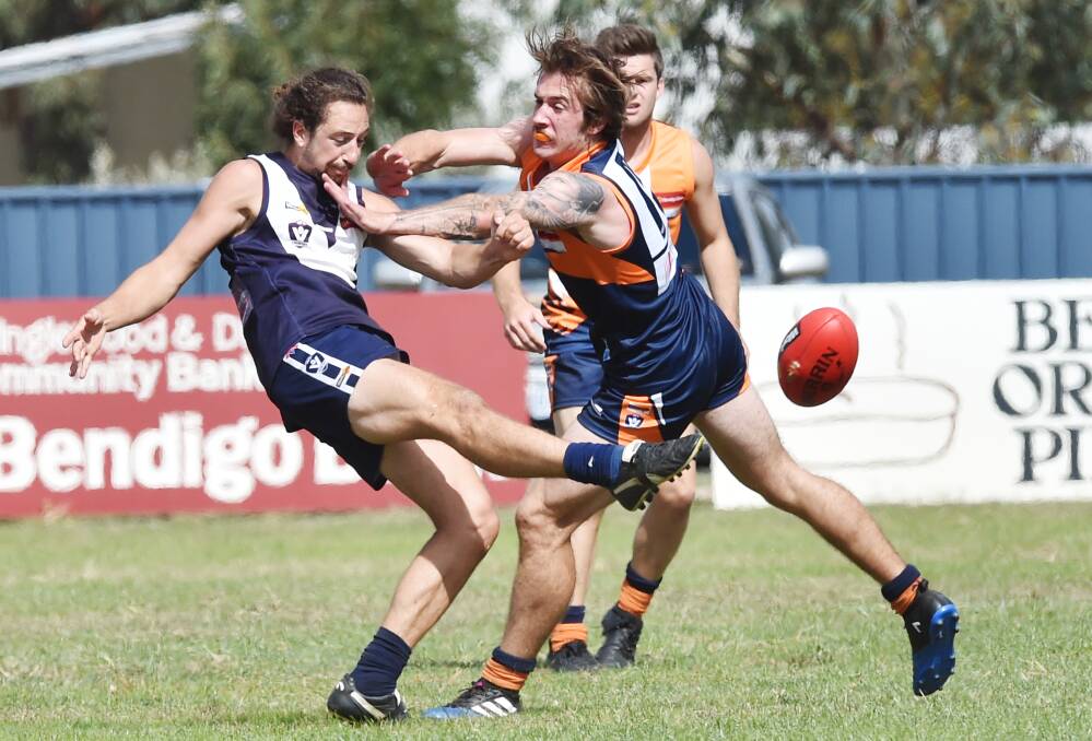 CONTEST: Inglewood's Nick Dower gets a kick away under pressure against Maiden Gully YCW Eagles on Saturday. Picture: DARREN HOWE