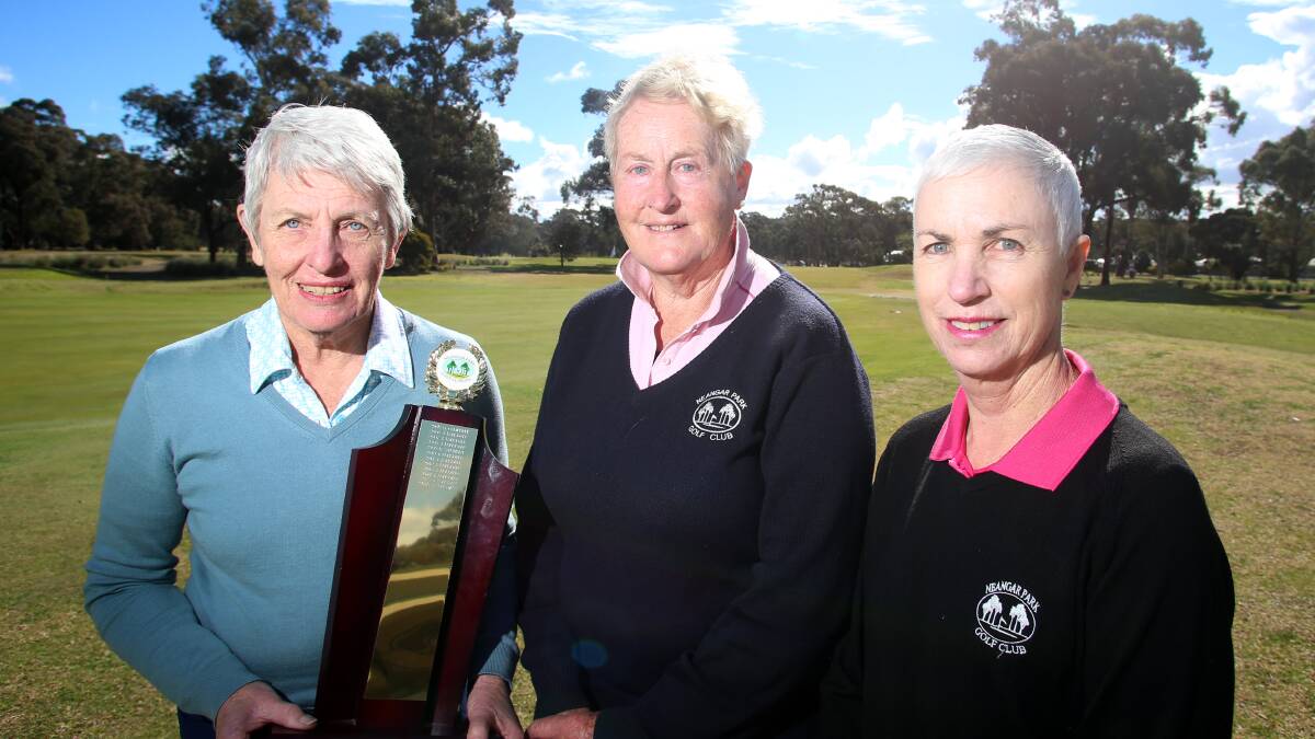 WELL PLAYED: Frank Prowse's grandaughter Ronda Henderson presents the winner's trophy to Annette Brown and Jenni Biggs. Picture: GLENN DANIELS