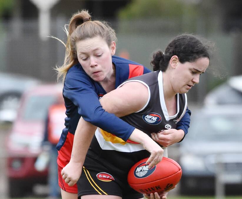 WRAPPED UP: The Bendigo's Thunder's Ashlee McLeod is caught in a tackle against Diamond Creek at Weeroona Oval on Sunday. Pictures: GLENN DANIELS