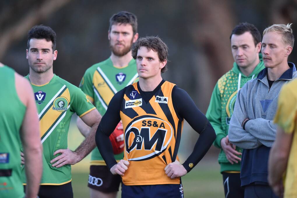 BUILD-UP: Colbinabbin players, including Todd Bryant wearing the O & M jumper, listen to coach Julian Bull at training this week. The Grasshoppers are playing in their first grand final since 2009 on Saturday. Picture: GLENN DANIELS