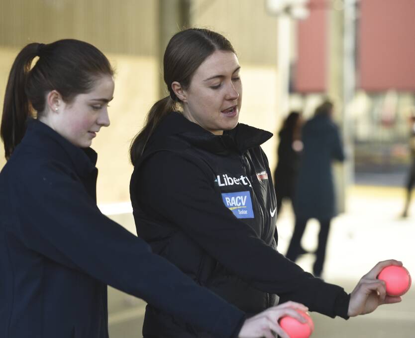 ADVICE: Bendigo's Tayla Vlaeminck gives Ariele Sea some bowling tips at Catherine McAuley College on Wednesday as part of the Renegades Regional Roadshow. Pictures: NONI HYETT