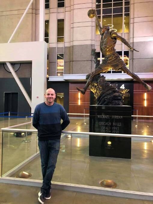 Adam Ryan in front of the Michael Jordan statue at Chicago's United Centre.