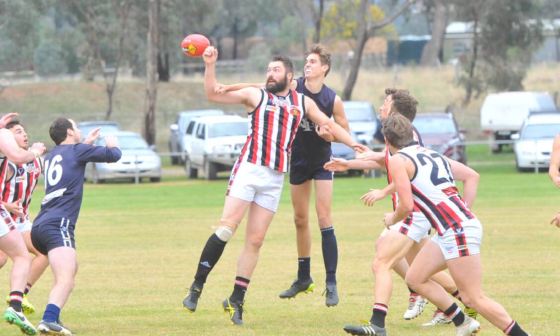 TAP: Heathcote's Carl Obst wins this ruck duel early in the first quarter of Saturday's victory over Mount Pleasant. Picture: LUKE WEST