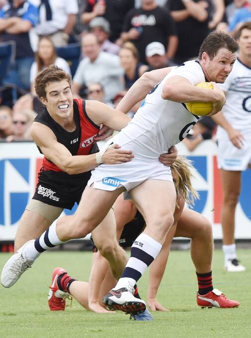 GOTCHA: Essendon's Zach Merrett tackles Geelong's Patrick Dangerfield, who racked up 38 possessions for the Cats. Picture: DARREN HOWE