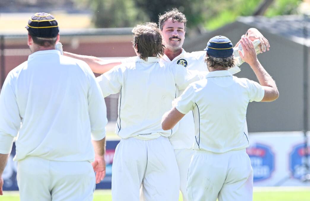 Bendigo players get around Nathan Fitzpatrick after a wicket on Saturday. Picture by Darren Howe