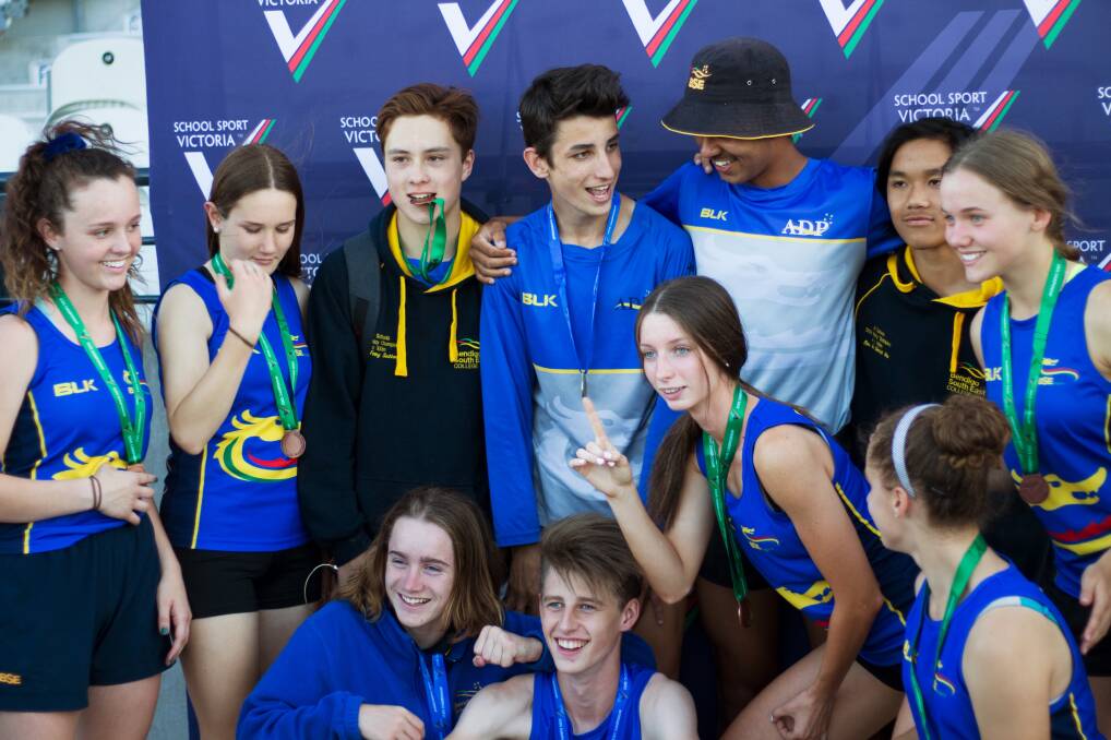 ALL SMILES: Members of Bendigo South East College celebrate their success in various relay finals at Lakeside Stadium on Monday. Pictures: CONTRIBUTED