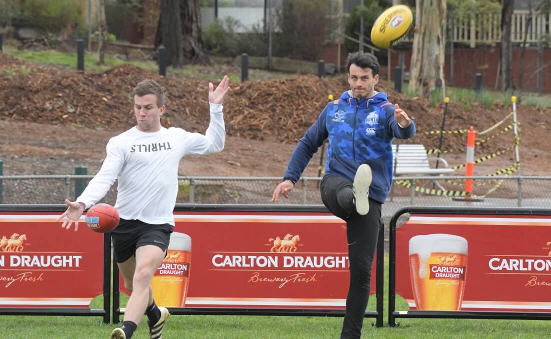 SUPERBOOTS: Sandhurst's Michael Dee and North Melbourne's Robbie Tarrant at Harry Trott Oval on Sunday. Picture: NONI HYETT