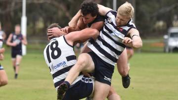 CRUNCH: Mount Pleasant co-coach Adam Baird is sandwiched in a contest against Lockington-Bamawm United at Toolleen on Saturday. Picture: NONI HYETT