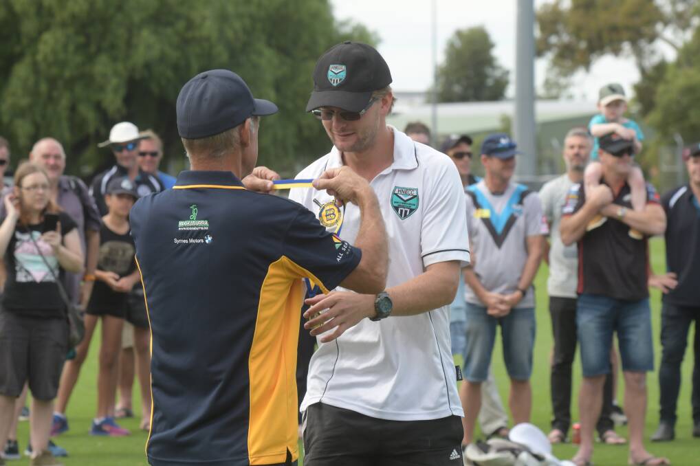 STAR PERFORMER: Huntly-North Epsom's Mitch Whittle receives his premiership medal following his 5-22 against Golden Square in the weekend's grand final.