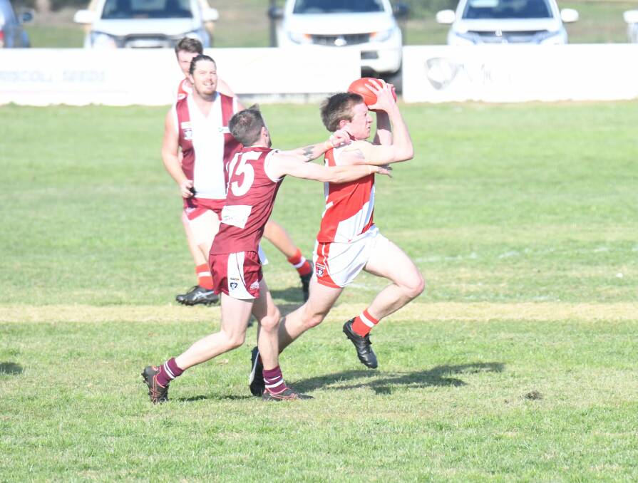 CENTRE CLEARANCE: Bridgewater's Emile Pavlich wins the ball in the middle under pressure from Newbridge's Jordan Anderson on Saturday. Picture: LUKE WEST