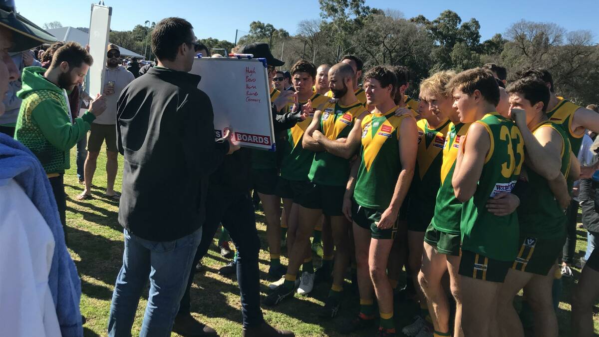 Colbinabbin players listen to coach Julian Bull at quarter-time on Saturday. Picture: LUKE WEST
